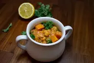 Curried_Chickpeas_with_Fresh_Cilantro_Spicy_Curry_Treat_Savory_Chickpea_Dish_Flavorful_Herb_Aromatic_Delight_Healthy_Cuisine_Nutritious_Recipe_Wholesome_Deliciousness_Ayurvedic_Cooking_Fresh_Cilantro_Aroma_Satisfying_Meal_Vegan_Fare_Ayurvedic_Food_Ayurveda